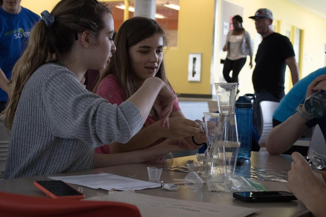 Teams hard at work on a 2019 SciEngTech Challenge Station.