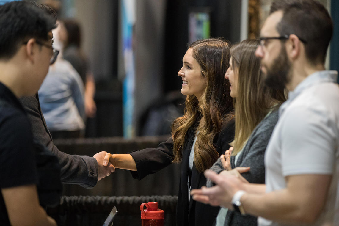 Two people shake hands