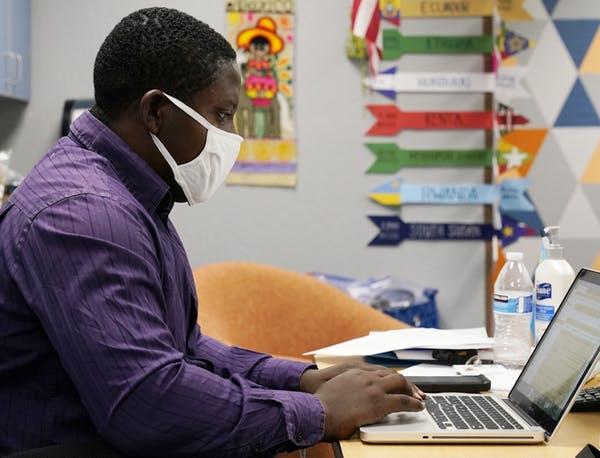 Teaching assistant Samuel Lavi works with an online class at the Valencia Newcomer School, Sept. 2, 2020, in Phoenix.